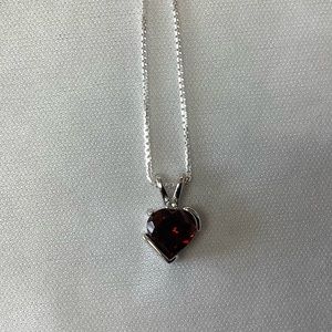 Garnet, heart shaped with diamond pendant  on a sterling silver 16” chain.